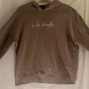 Light brown hoodie with white print “à la mode” (fashionable in french)
